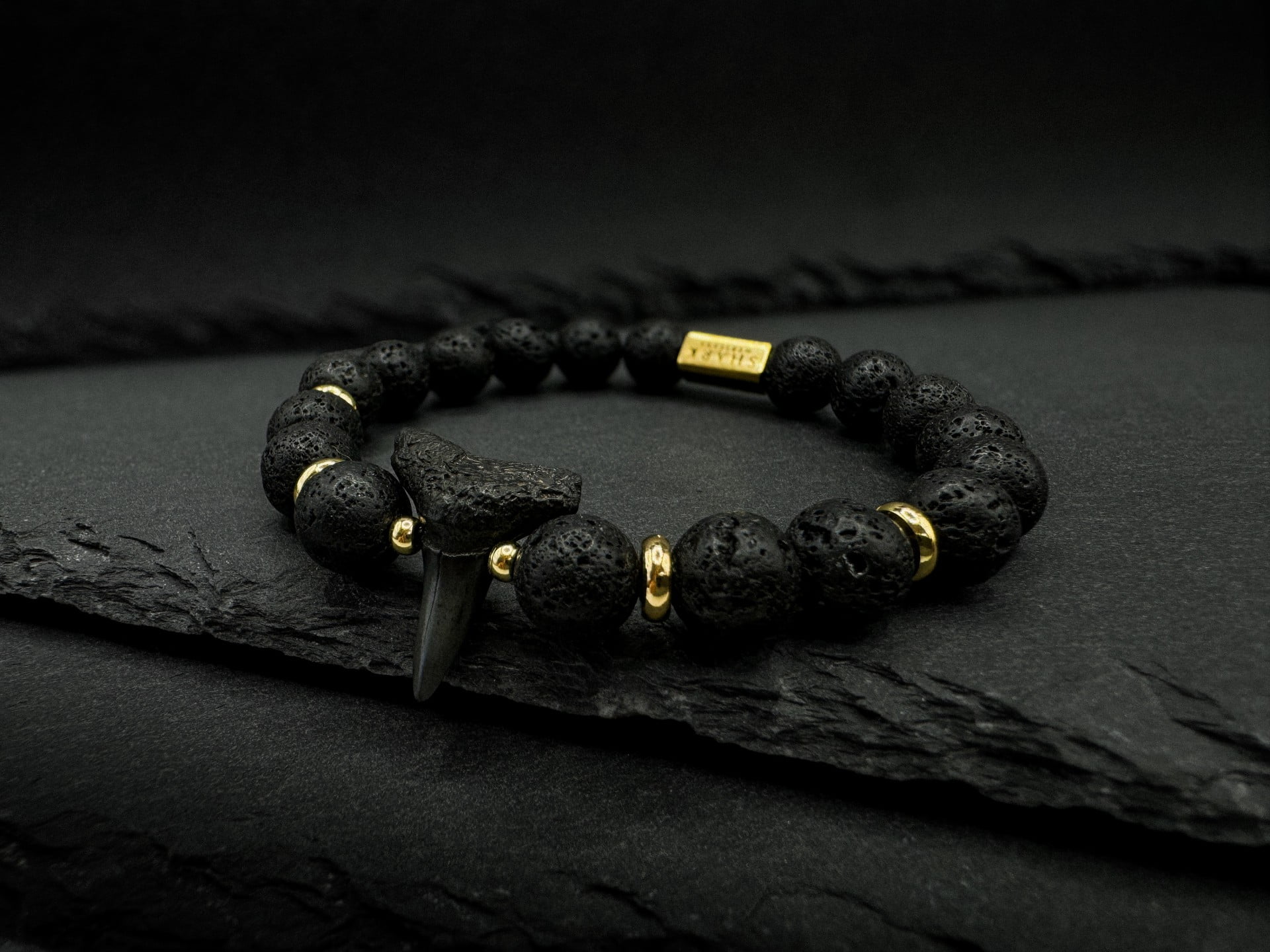 fossil shark tooth bracelet with lava stone and 18k gold plated beads